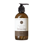 Brown bottle of all-natural luminous bronzing lotion with pump on a white background