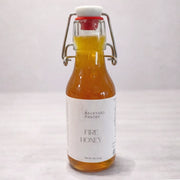 Bottle of 'Fire Honey' from The Backyard Pantry on a white background