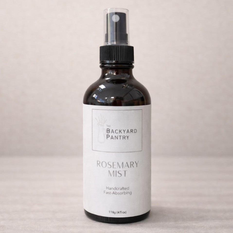 Bottle of Backyard Pantry Rosemary Mist on a beige background