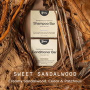 Shampoo and conditioner bars with sweet sandalwood scent surrounded by natural elements.