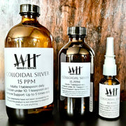 Three bottles of Warrior's Heritage Colloidal Silver on a wooden background
